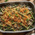 Green bean casserole from scratch in a baking dish topped with crispy fried shallots and golden panko