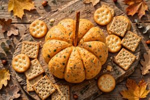 Pumpkin cheese ball shaped like a mini pumpkin with crackers