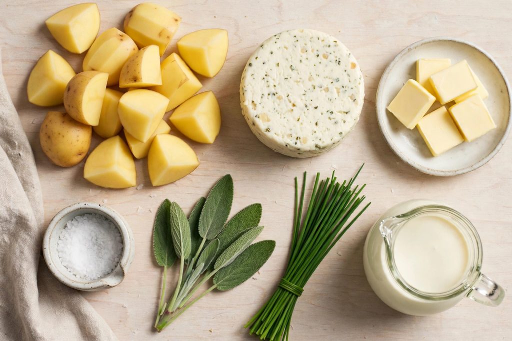 Flat-lay of Yukon Gold potatoes, Boursin cheese, butter and cream